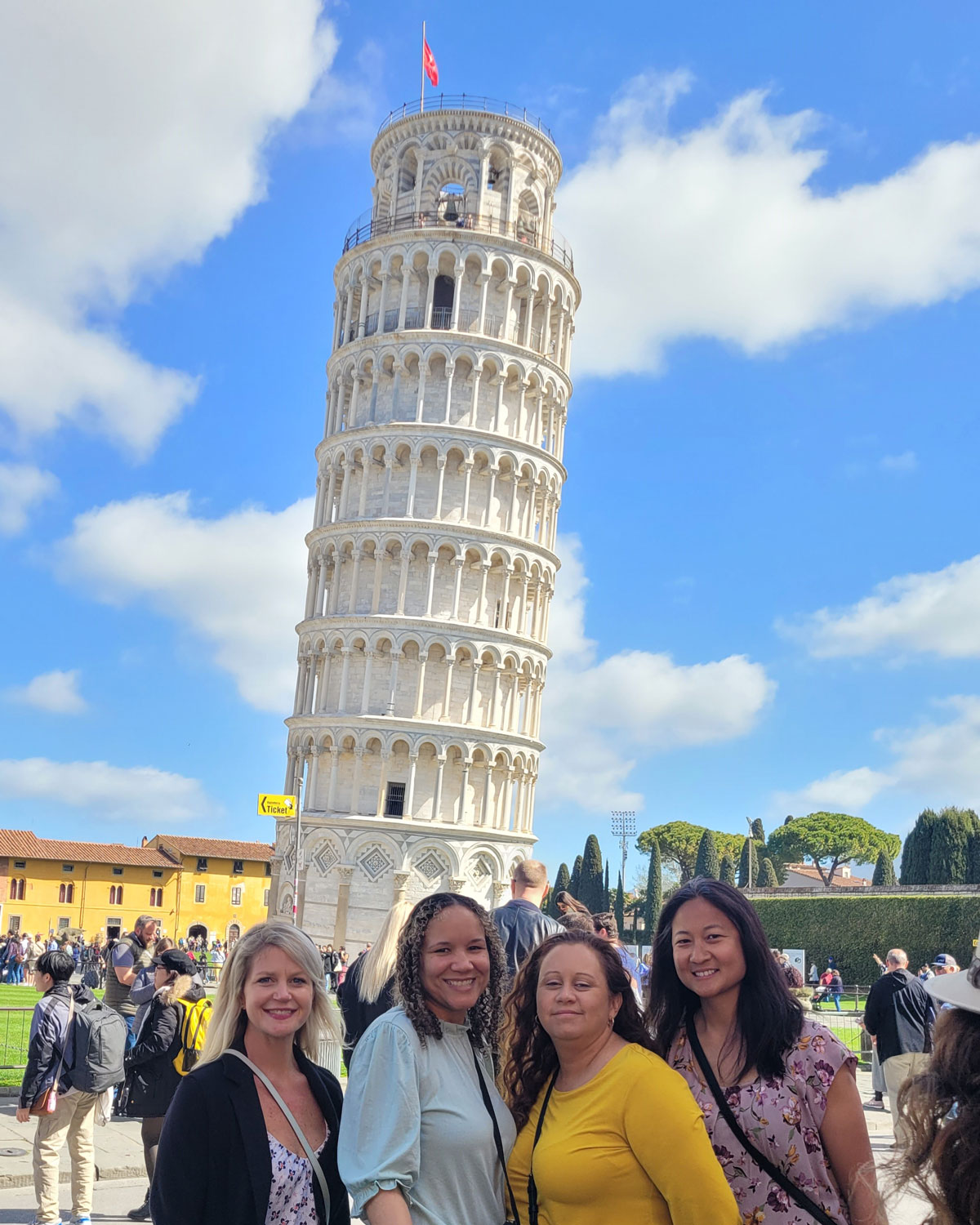 Teachers standing in front of the Leaning Tower of Pisa